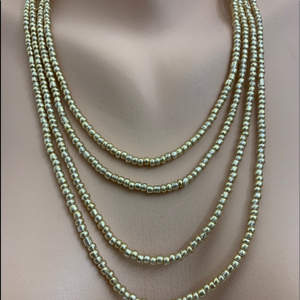 Gold tone beads four strand necklace